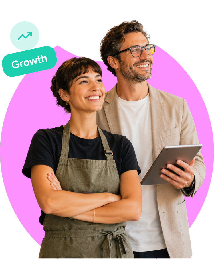 Small business owners standing together with a tablet